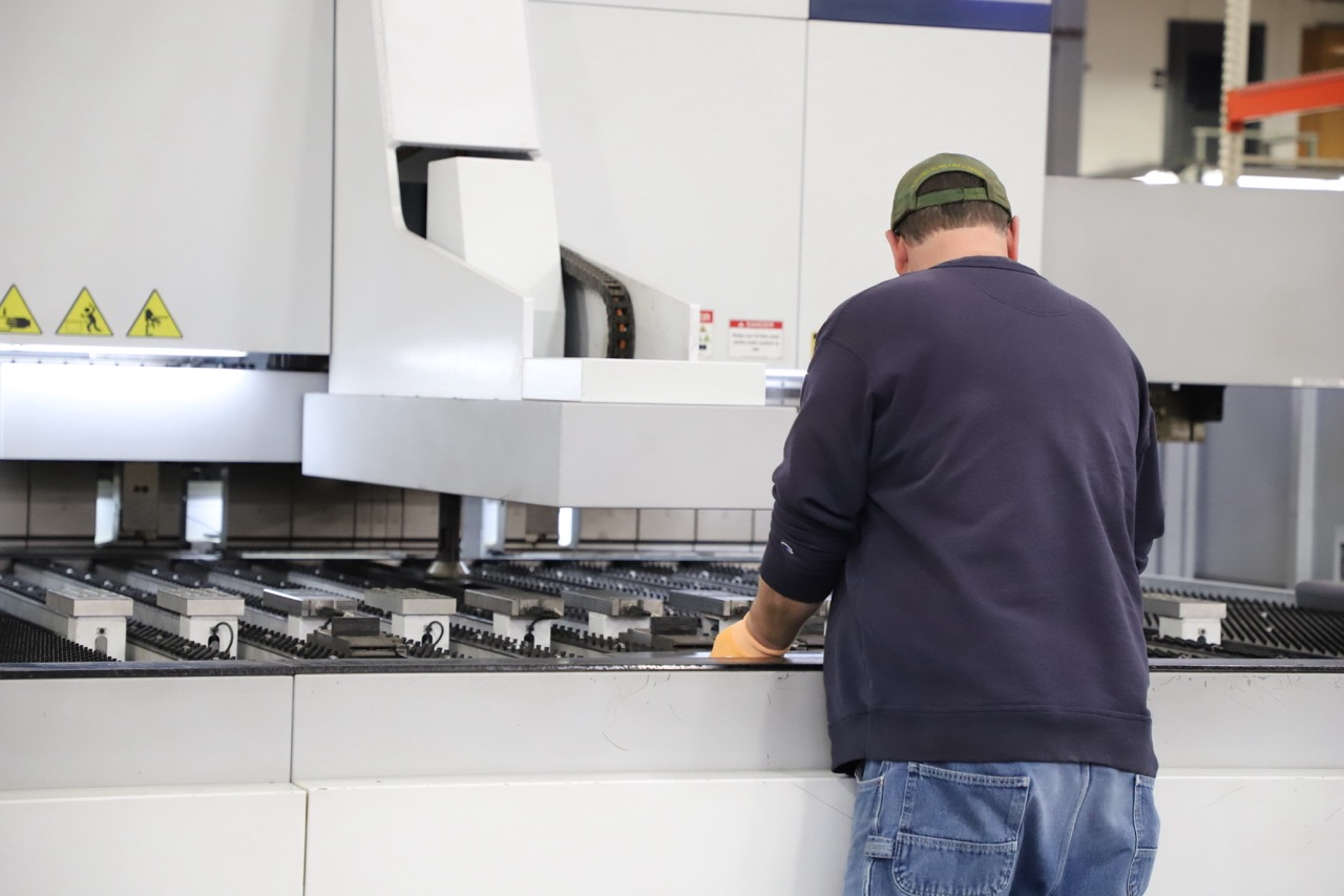 Industrial CNC machining process cutting a precision metal component with coolant spray