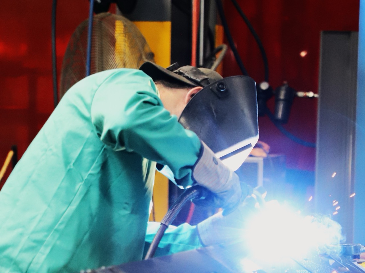 Angle grinder cutting metal — sparks flying across a steel workpiece