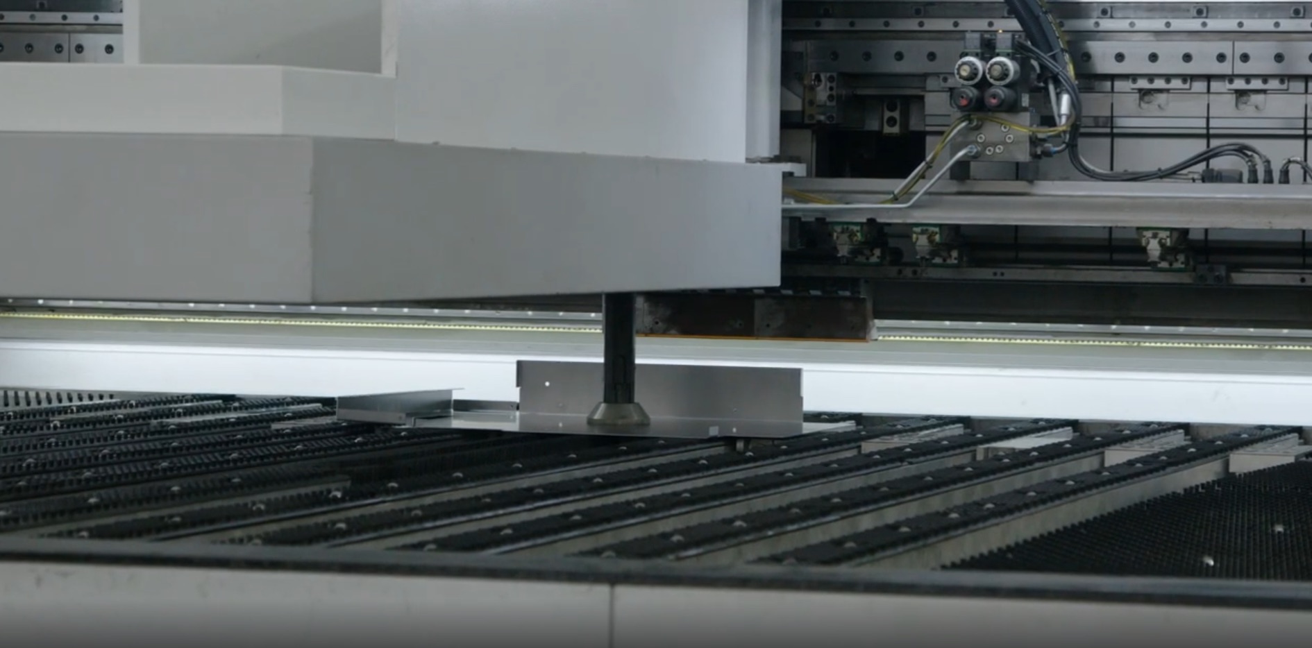 Automated industrial conveyor system transporting packaged materials through a manufacturing facility